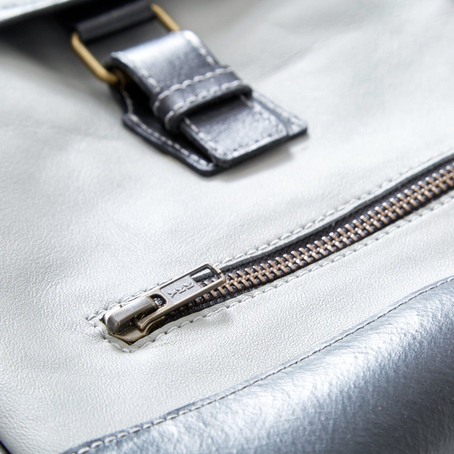 Closer view of The Miina Hudson messenger bag made with grey upcycled aircraft leather