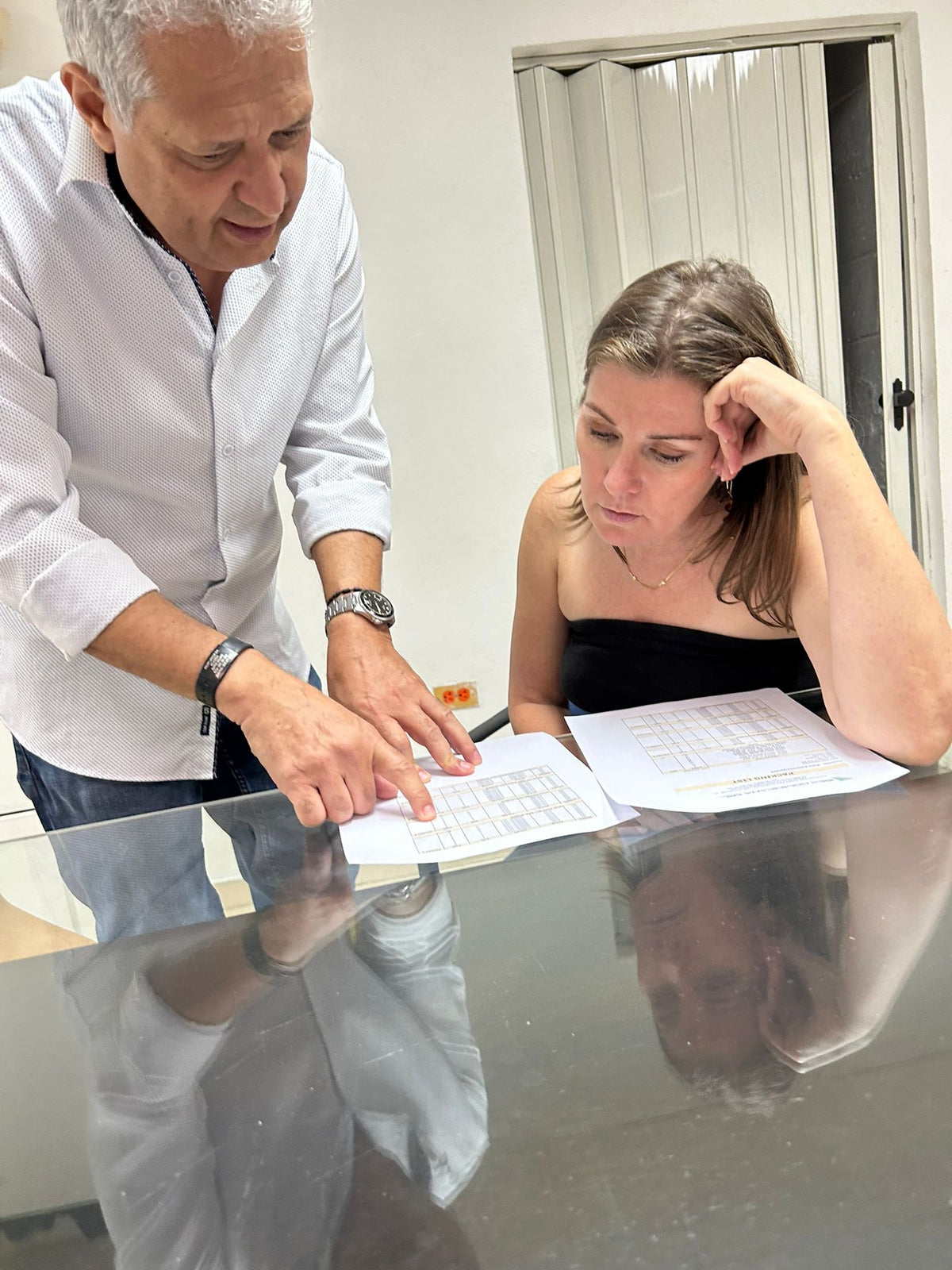Christal Duncan and Philipp Laraque looking at the Miina Goods shipment they are working on together. 