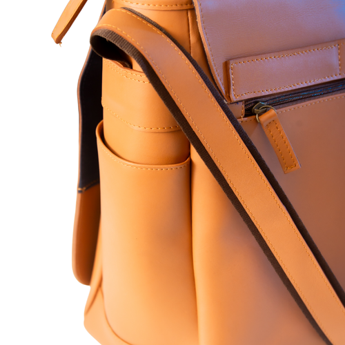 Close-up of El Unico leather travel bag from Miina Goods with a matching shoulder strap, front zip pocket, and side pocket on a white background.