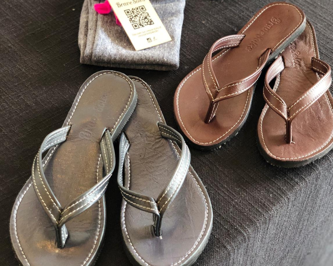 Brave Soles sandals displayed on a table  in a corporate gifting event