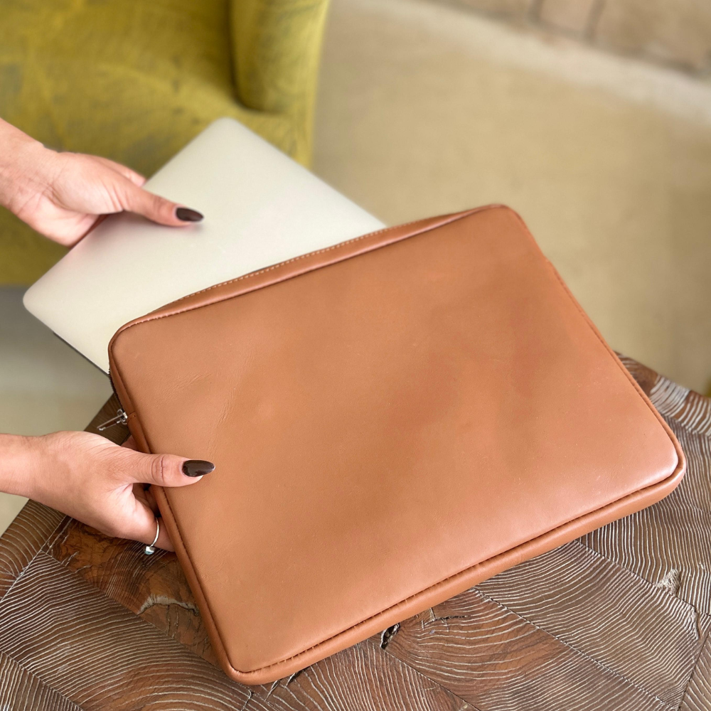 Simpatico eco conscious leather travel laptop case being used with a model's hands